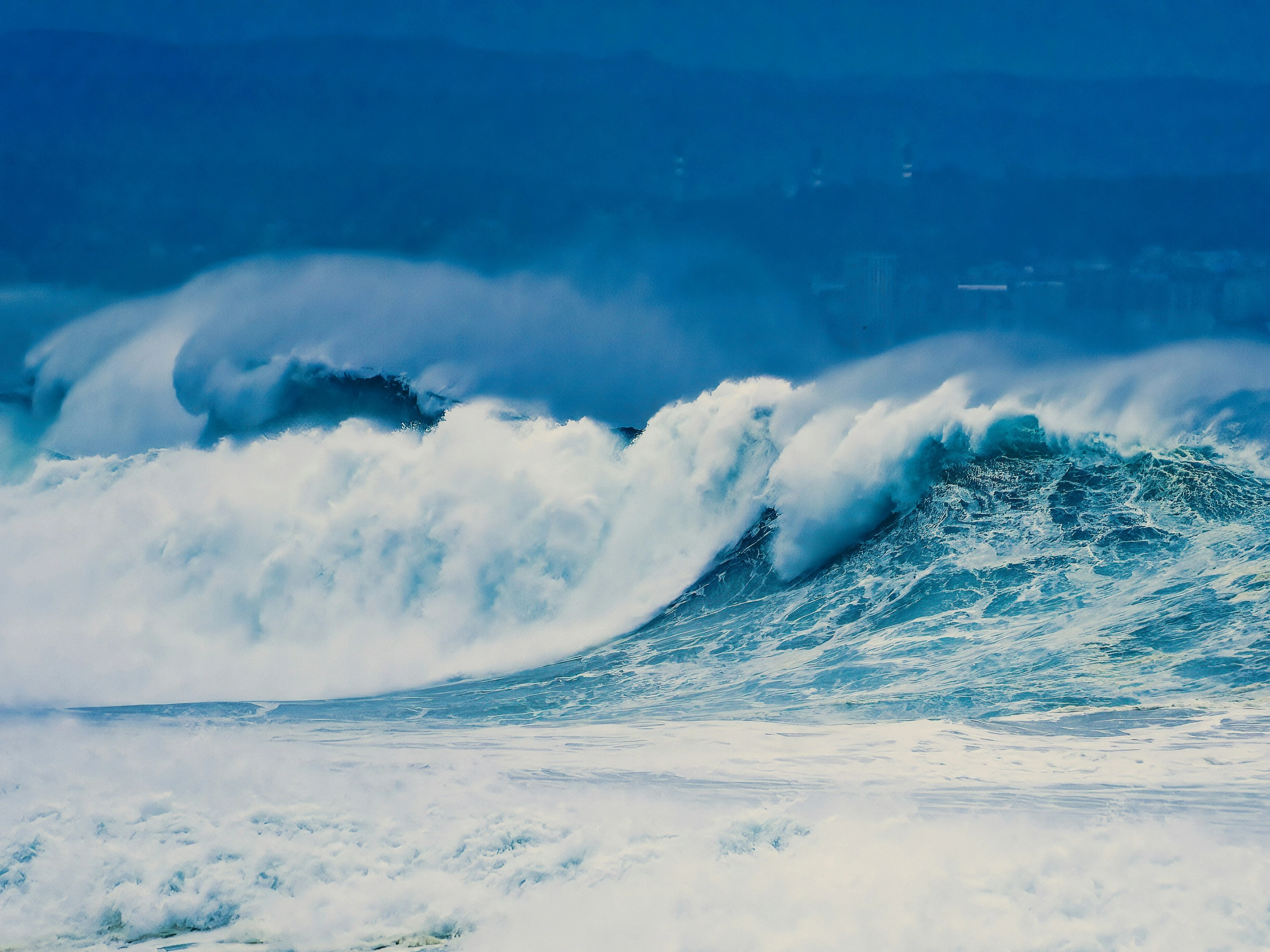 a large wave is breaking over the ocean